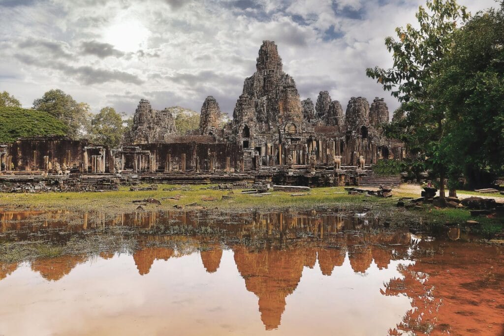The Bayon Temple reflected in a pool of water at Angkor Thom