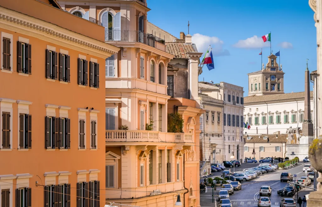 The Italian flag flies over the clock tower of the Palazzo del Quirinale (Quirinal Palace) in the historic heart of Rome. The Quirinal Palace is currently the official seat of the President of the Italian Republic, elected every seven years by the Italian Parliament. Built in neoclassical style on the Quirinal Hill between 1573 and 1583 as the summer residence of Pope Gregory XIII, this palace over the centuries has been the residence of the Popes (1605-1870), the residence of the King of Italy (1871-1946) and official seat of the Presidency of the Republic (from 1946 to today). Some of the most important Italian architects and artists participated in its construction and decoration, including Gian Lorenzo Bernini, Carlo Maderno, Guido Reni and Domenico Fontana. The Quirinal Palace, with an extension of 110,000 square meters, is the sixth largest building in the world. In 1980 the historic center of Rome was declared a World Heritage Site by Unesco.