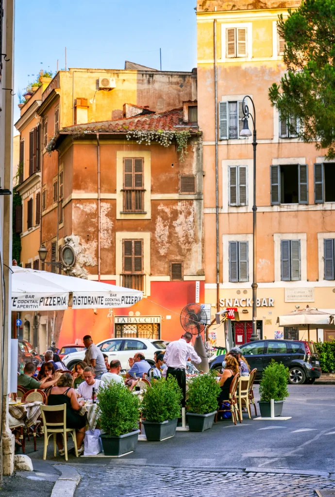 Rome, Italy, July 22 -- A suggestive glimpse of the Rione Monti (Monti District), in the heart of the historic center of Rome, with a lovely restaurant between the facades of some ancient buildings in Piazza Corrado Ricci. The Monti district is a popular and multi-ethnic quarter much loved by the younger generations and tourists for the presence of trendy pubs, fashion shops and restaurants, where you can find the true soul of the Eternal City. This district, located between the Esquiline Hill and the Roman Forum, is also rich in numerous Baroque-style churches and archaeological remains from the Roman era. In 1980 the historic center of Rome was declared a World Heritage Site by Unesco.