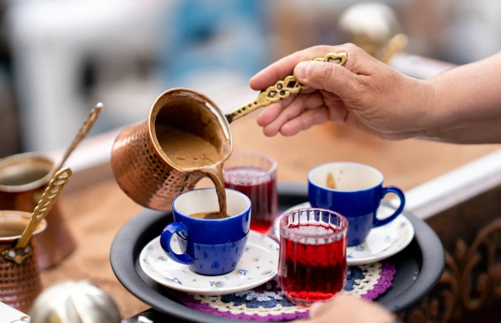 Brewing Turkish coffee on hot sand. The traditional method of making coffee in Turkey and the Middle East