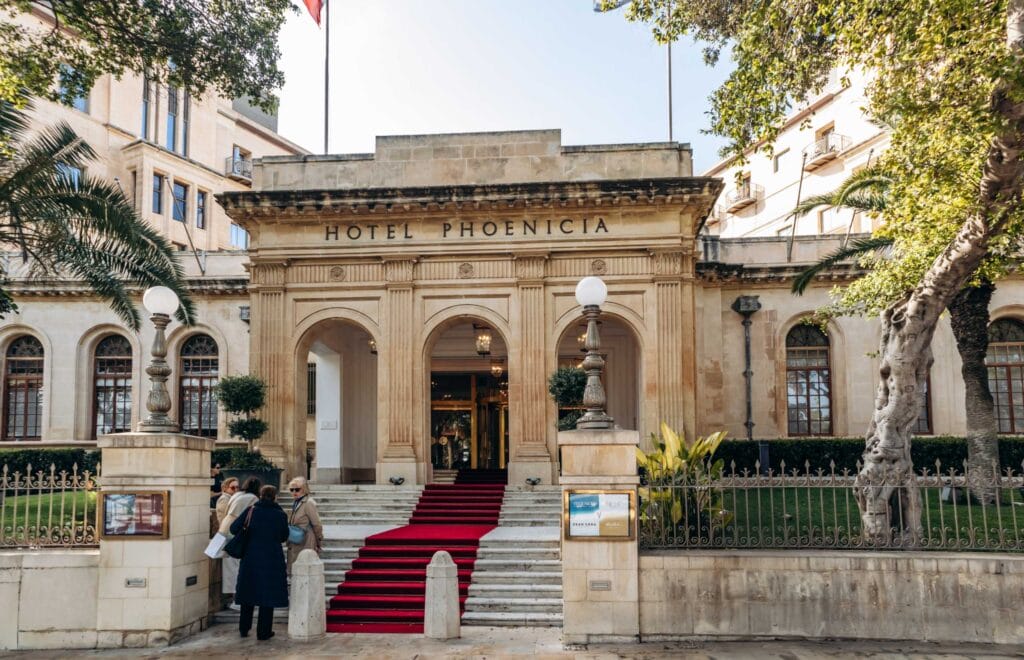 Exterior view of the historic Hotel Phoenicia in Valletta, Malta, with its grand entrance and red carpet welcoming guests