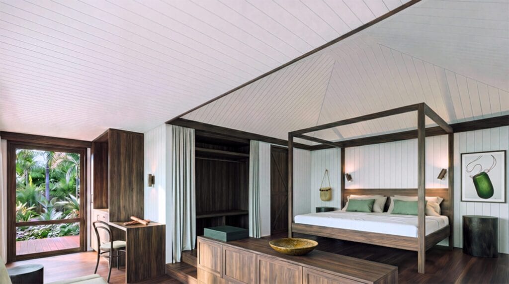 Queenslander suite interior at Ever Bloomfield with four-poster bed and louvred windows to rainforest