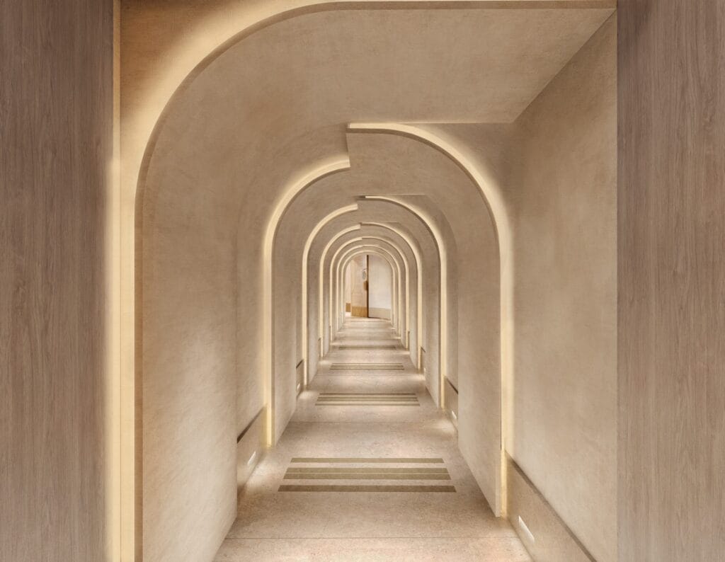 The spa arrival corridor at Waldorf Astoria London Admiralty Arch, featuring vaulted cream arches and warm cove lighting