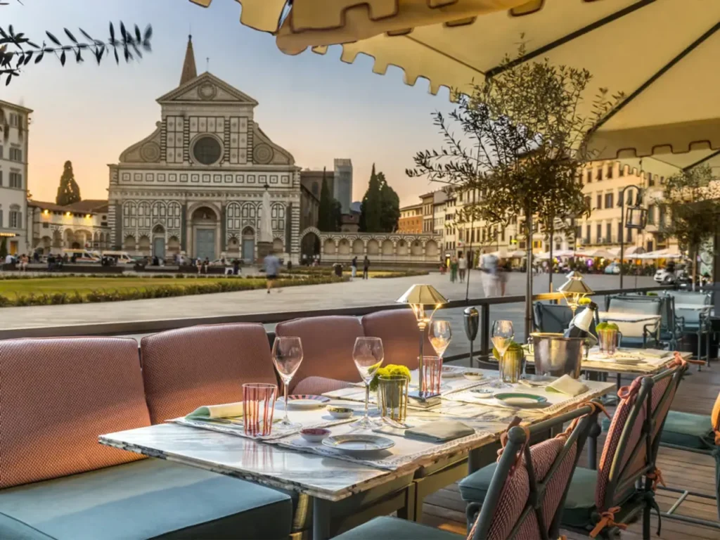 Ddining terrace at The Place Firenze hotel, offering a direct view of the Basilica of Santa Maria Novella