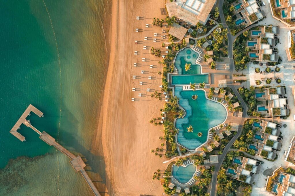 Aerial view of pool complex and beachfront at Six Senses AMAALA