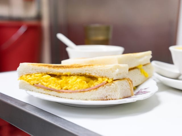 A classic toasted ham and scrambled egg sandwich served at the famous Australia Dairy Company 