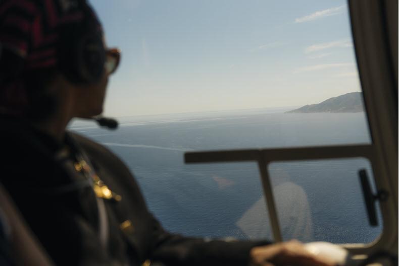 A coastal landscape viewed from a helicopter window during a The Luxury Collection Expeditions