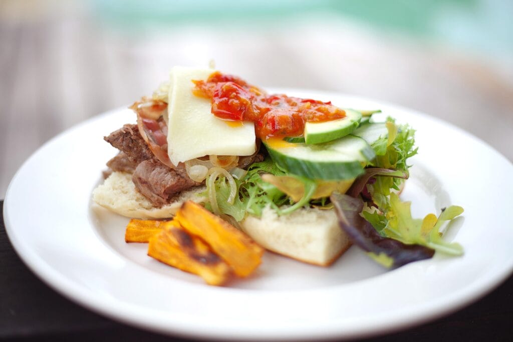 An open-faced steak sandwich on a white roll at Bamurru Plains