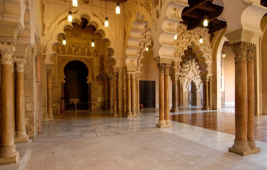 intricate arches and columns inside the historic Aljafería Palace