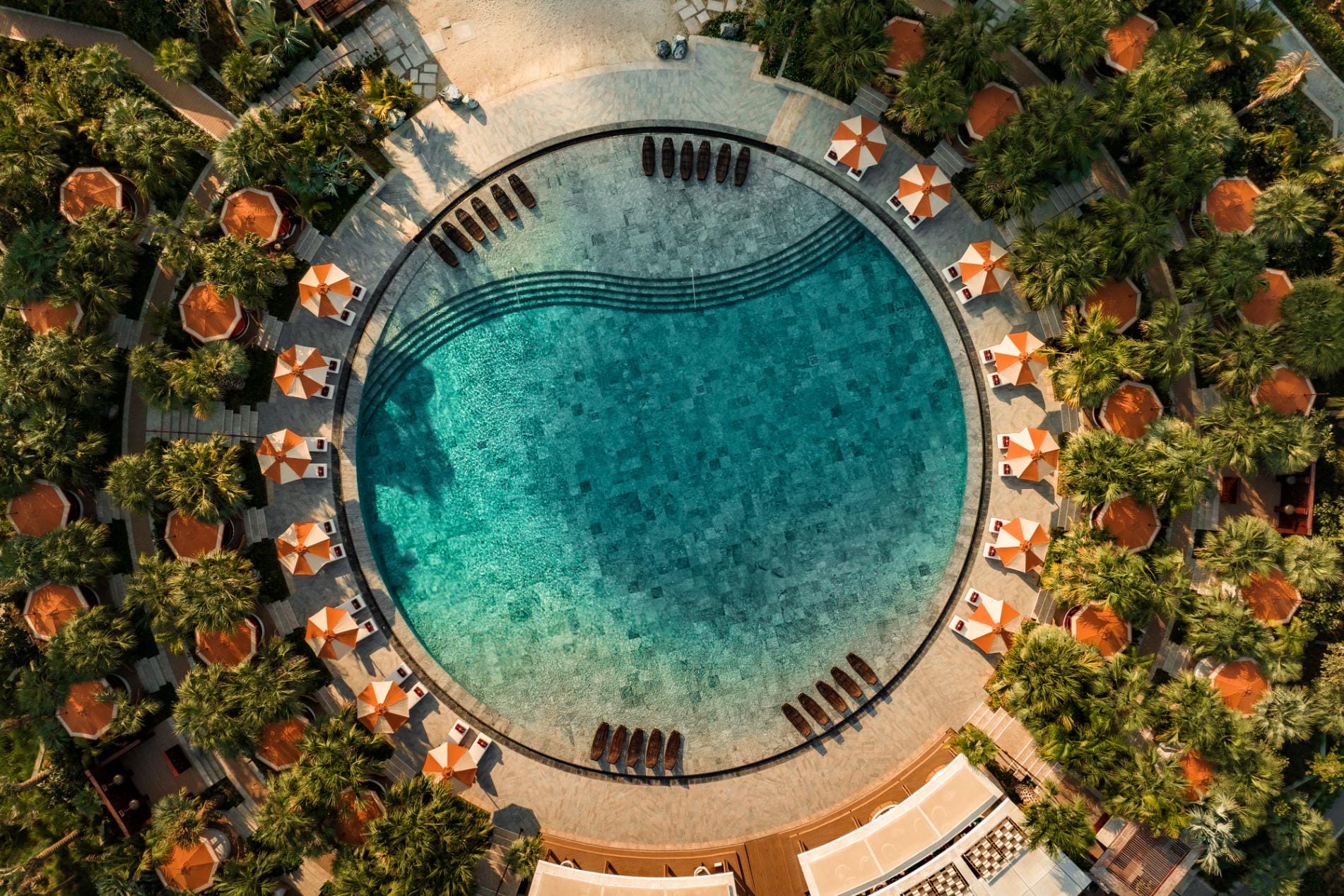 Swimming pool surrounded by private cabanas and palm trees at the ultra-luxury Jumeirah Marsa Al Arab