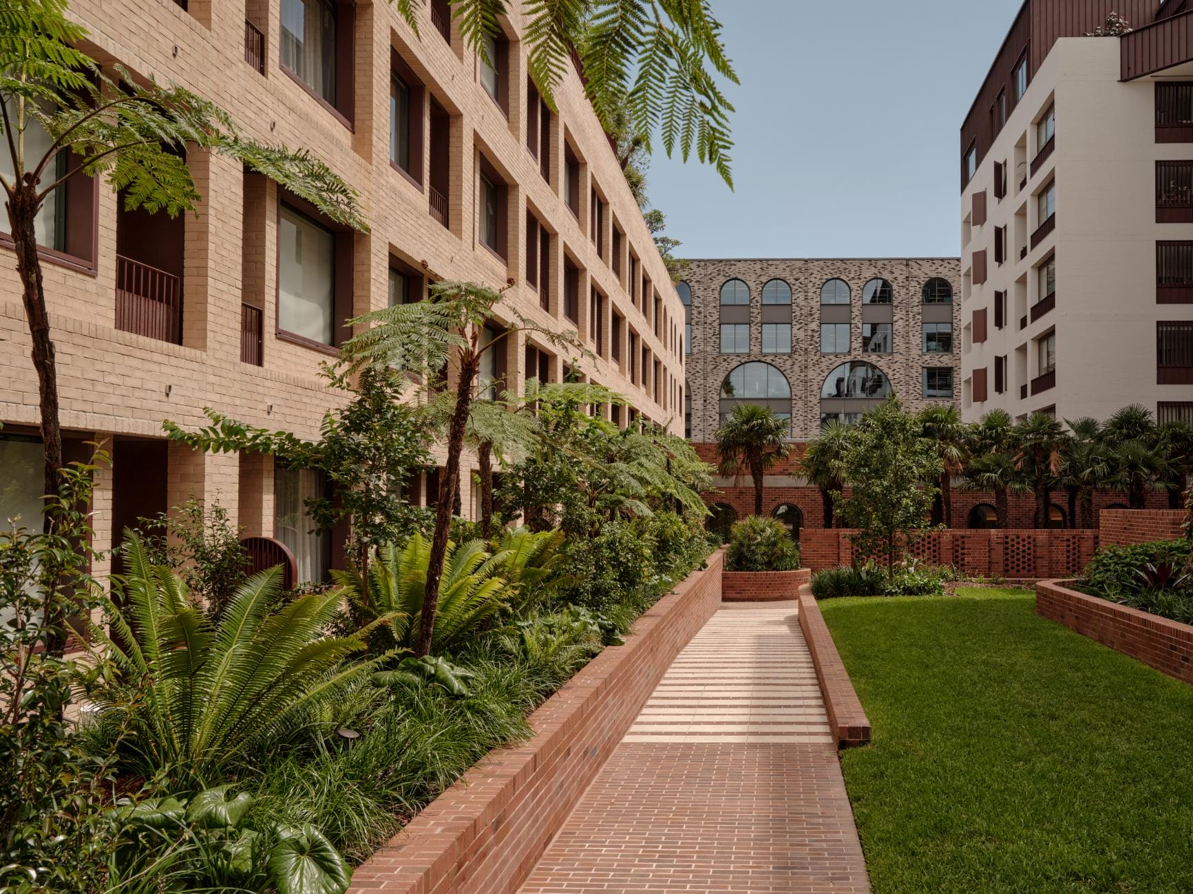 Landscaped courtyard and brick architecture at The EVE Hotel Sydney