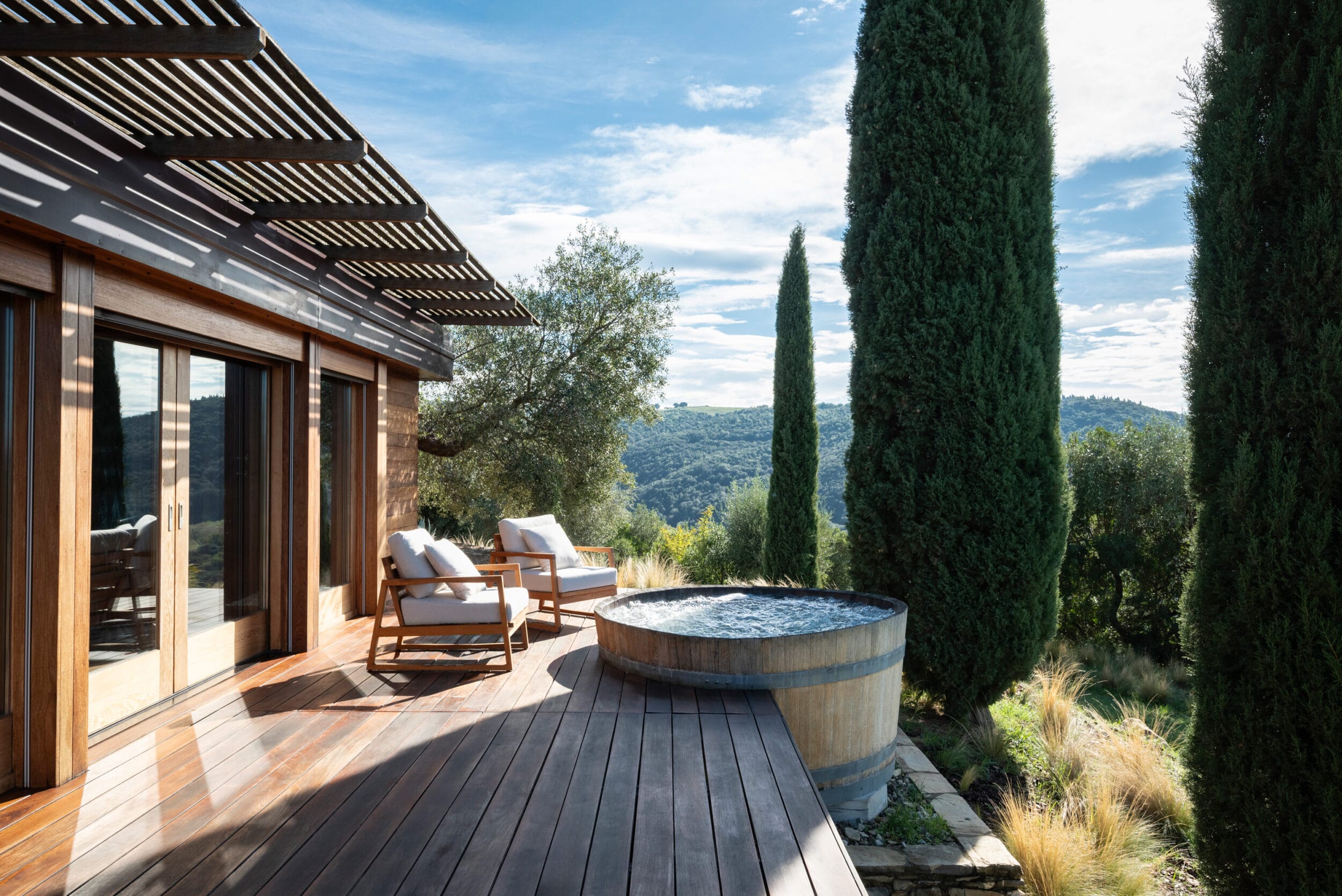 Private wooden deck and oak wine barrel hot tub of the Spa Suite at Castello di Vicarello. Image credit: Matteo Serpi