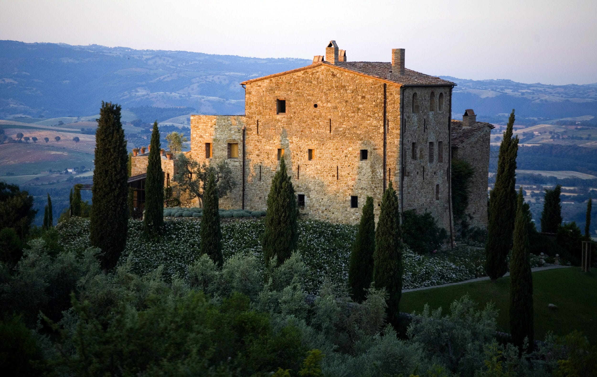 Historic Castello di Vicarello set against the rolling hills of Tuscany, Italy