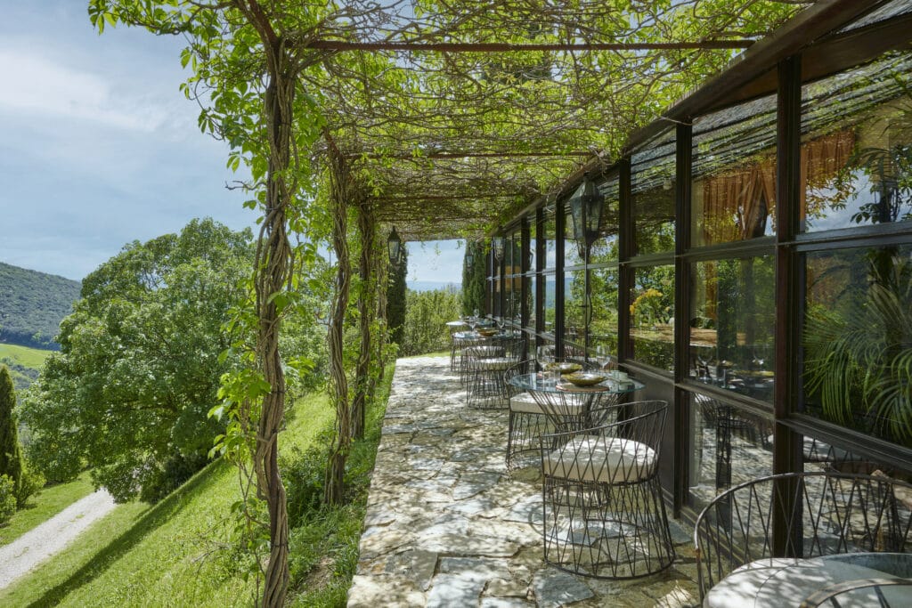 Sunlit outdoor dining terrace at Castello di Vicarello. Image credit: Valentina Sommariva