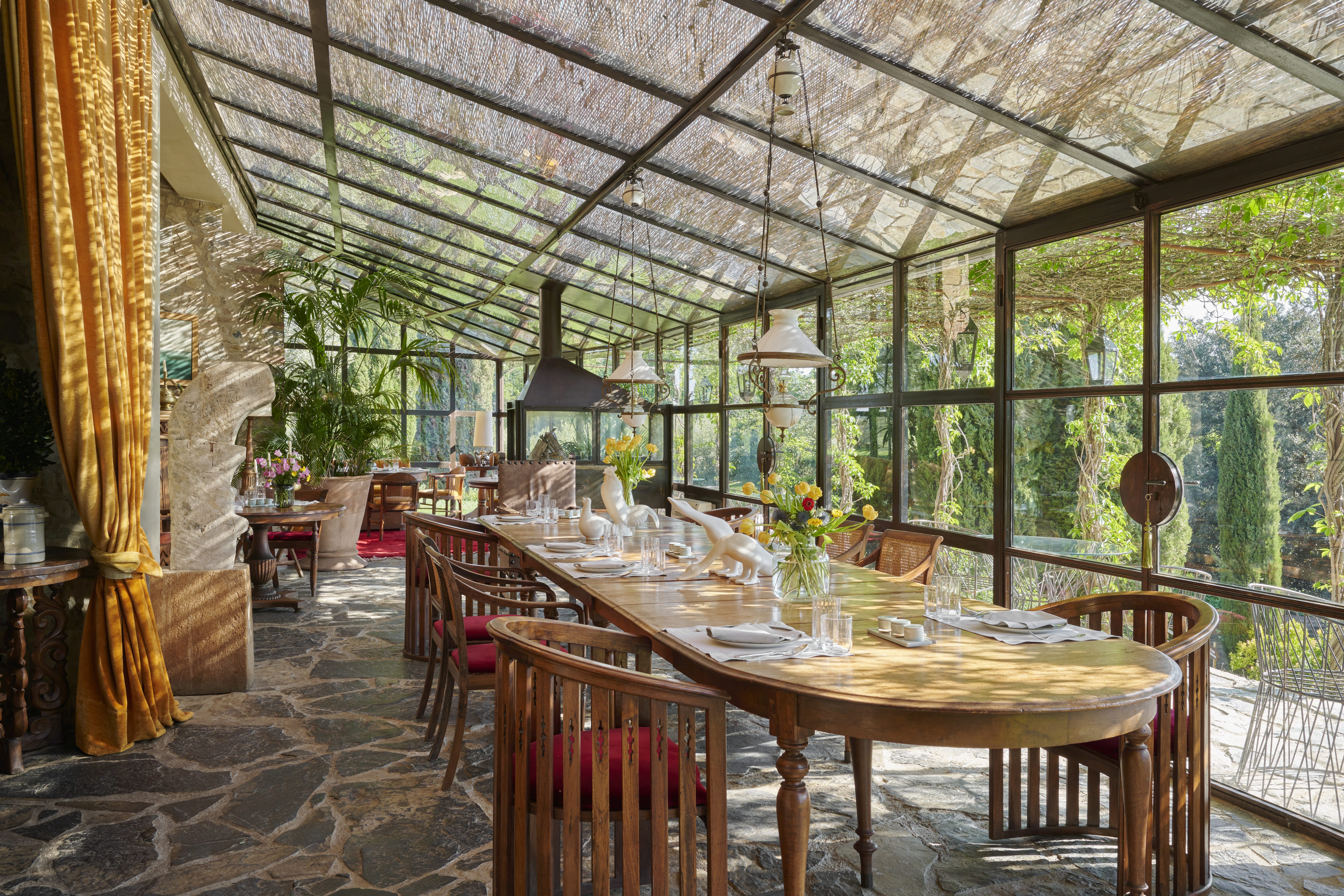 Glass-enclosed conservatory dining room at the Castello di Vicarello. Image credit: Valentina Sommariva