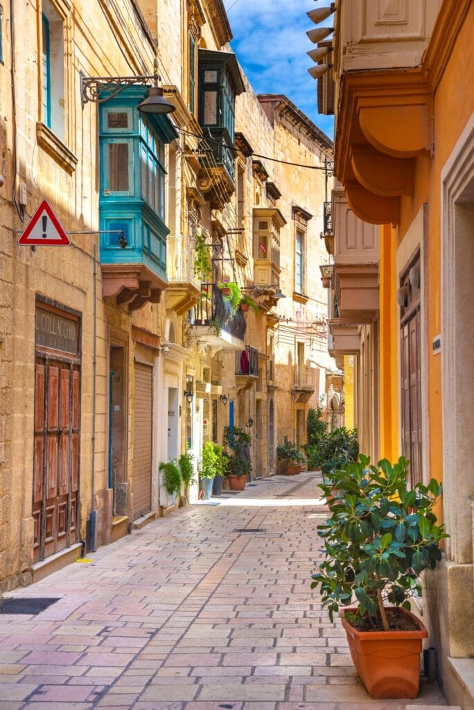 This narrow, sunlit street is located on Hilda Tabone Street in Birgu (also known as Vittoriosa), one of Malta's historic Three Cities