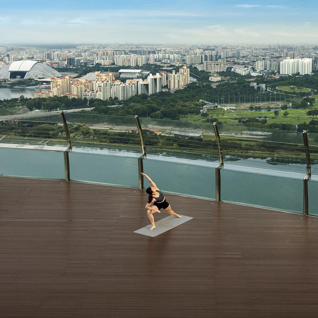 Yoga on the wooden deck of the Sands SkyPark Observation Deck at Marina Bay Sands