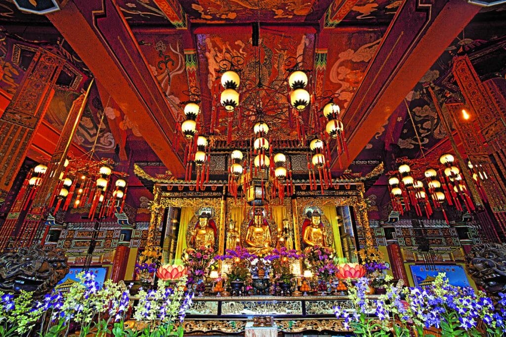 The image shows the ornate interior of the Main Shrine Hall at the Po Lin Monastery