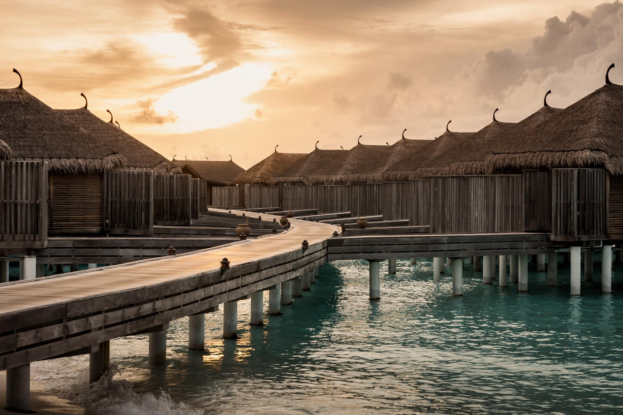 Overwater villas at Constance Moofushi Maldives during sunset