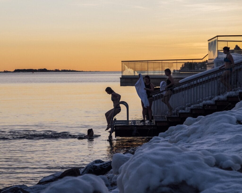 Taking a cold plunge in the Baltic Sea near the Löyly sauna in Helsinki